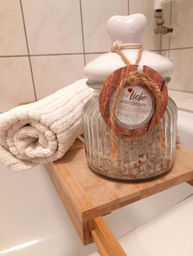 a bottle of soap on a wooden shelf in a bathroom at FEWO Geborgenheit ASZA mit strahlungsfreien Zonen in Bautzen
