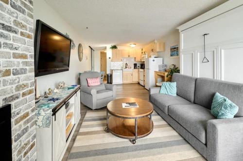 a living room with a couch and a table at Oceanfront Condo - Second Floor - Pet Friendly in Lincoln City