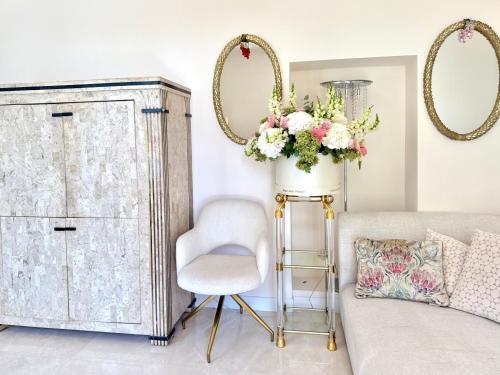 a living room with a chair and a dresser at Monaco 2bdr luxury apartment, private garden&pool in Beausoleil