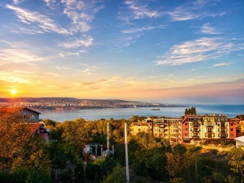 a view of a city and a river at sunset at Villa Avelia - Sea View Jacuzzi Retreat in Varna City