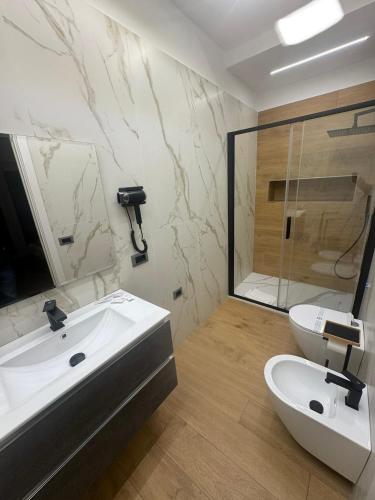 a bathroom with a sink and a shower and a toilet at Costa blu in Agropoli