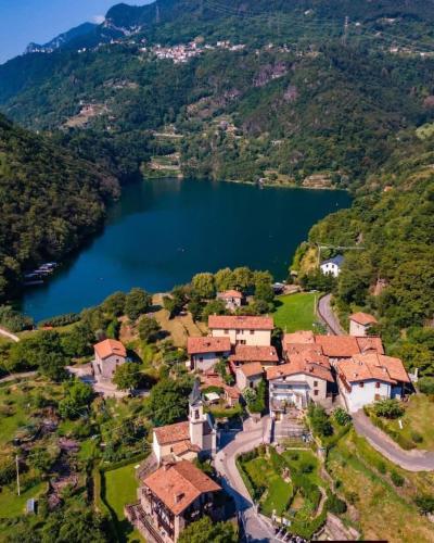 an aerial view of a house on a hill next to a lake at Casa vacanze "INCANTO DEL LAGO" in Corna