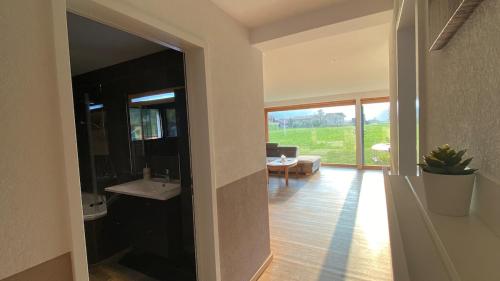 a hallway of a house with a view of a living room at Falke-Apart 1 am Wasserfall in Unterbach