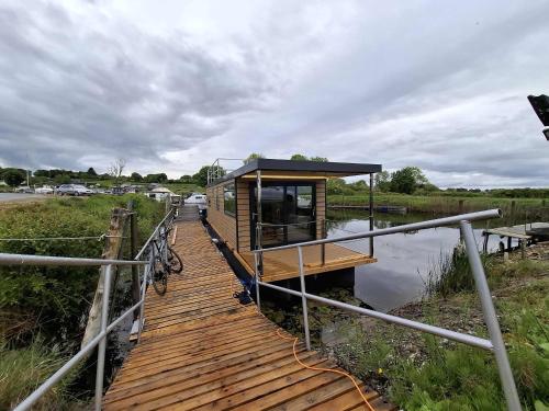 a tiny house on a dock in the water at Aquastay Drift in Athlone