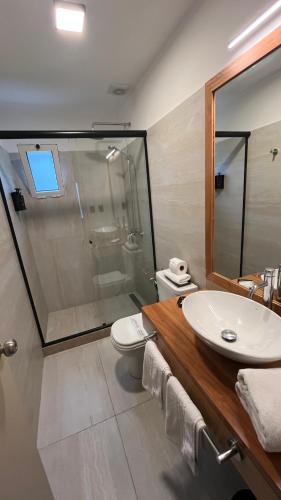 a bathroom with a sink and a toilet and a shower at Mercedes Rambla Hotel in Mercedes