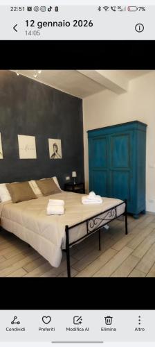 a bedroom with a bed and a blue cabinet at Gli Oleandri Rooms Casa Teresa in Conselice