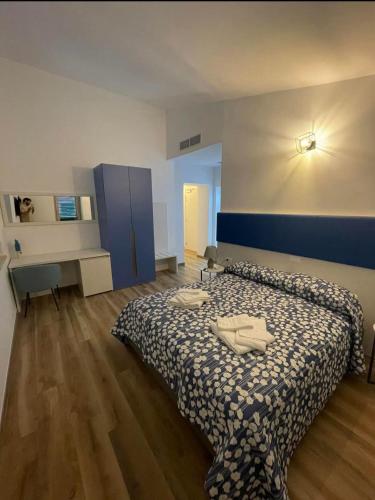 a bedroom with a bed and a desk in it at B&B Villa Mariotta in Amantea