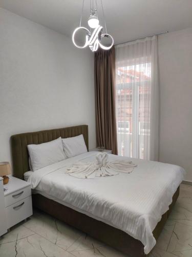a bedroom with a bed with a flower on it at Golden Guesthouse in Resen