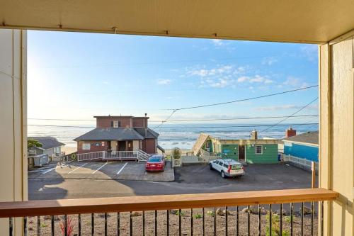 a view of the ocean from the balcony of a house at Ground Floor - Ocean View Condo - Pet-Friendly in Lincoln City