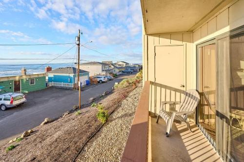 a bench on a balcony with a view of the ocean at Ground Floor - Ocean View Condo - Pet-Friendly in Lincoln City