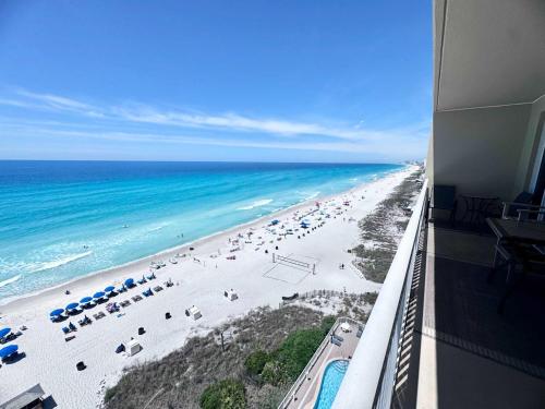 a view of a beach with umbrellas and the ocean at 2 BR Oceanfront Condo with Shared Pool & Hot Tub in Panama City Beach