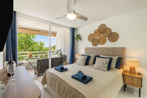 a bedroom with a bed with blue towels on it at Ocean Aura Tenerife in Costa de Adeje