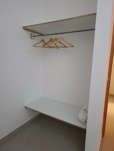 a closet with a white counter and a shelf at Ap Doce Lar in Espargos