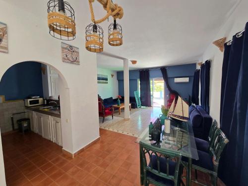a living room with blue walls and a table and chairs at lagoon apartement 1 in Moulay Bousselham