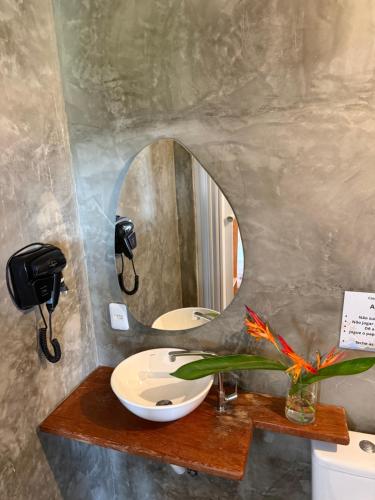 a bathroom with a sink and a mirror at Morada do Vento in Guriú