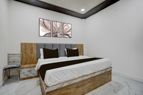 a bedroom with a large bed in a room at Hotel O Viraj Inn in Gwalior