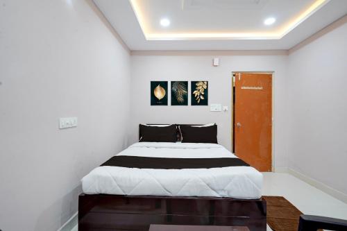 a bedroom with a large bed in a room at HOTEL O KMG GRAND in Bībīnagar
