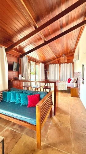 a large blue couch in a room with wooden ceilings at Casa boa vida in Jericoacoara