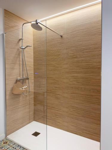 a shower with a glass door in a bathroom at Sorolla Urban Suites in Valencia