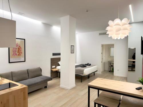 a living room with a couch and a table at Sorolla Urban Suites in Valencia