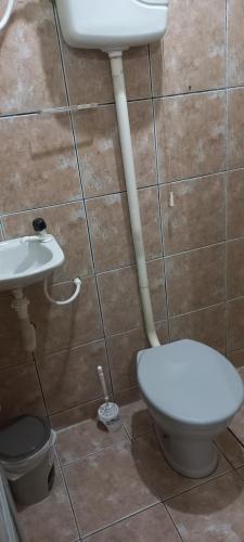 a bathroom with a toilet and a sink at Casa de Lagoa Nova in Martins