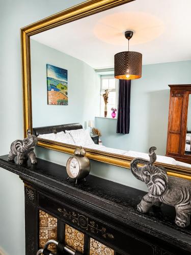 a mirror on top of a mantel in a bedroom at Nore View House in Kilkenny