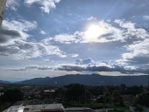 a cloudy sky with mountains in the background at Brisas de fusagasuga in Fusagasuga