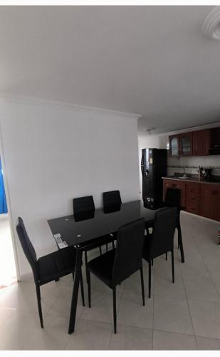 a black dining table and chairs in a kitchen at Brisas de fusagasuga in Fusagasuga