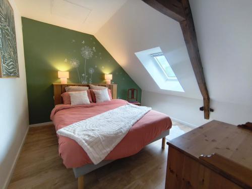 a bedroom with a large bed in a attic at Ty Noa - 2-bedroom cottage in Saint-Just