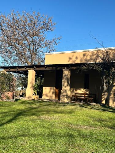 a building with a picnic table in a yard at Habitaciones Casona Las Toscas in Miramar