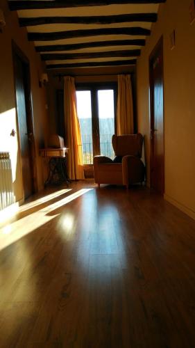 a living room with a couch and a large window at La Masia del Batlle in Sarroqueta