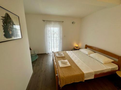 a bedroom with a bed in a room with a window at Liberty Apartments in Cetinje