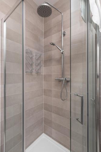 a shower stall with a glass door in a bathroom at Gorgeous Luxury in Lahinch