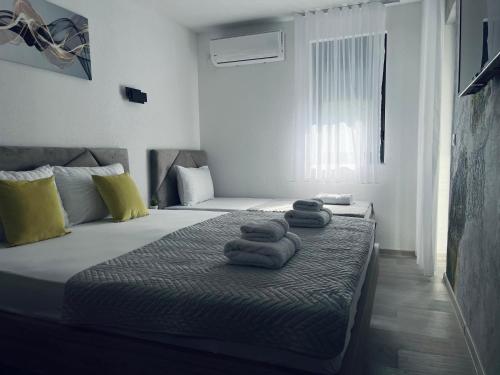 a bedroom with a bed with towels on it at Asteris Apartments in Demir Kapija