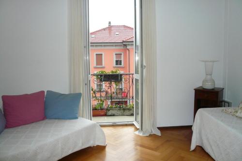 a living room with a couch and a large window at Casa Jolanda in Bellinzona
