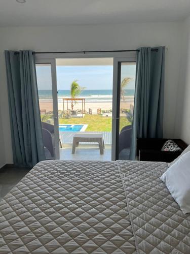 a bedroom with a bed and a view of the beach at Venice House, Costa del Sol in San Luis La Herradura
