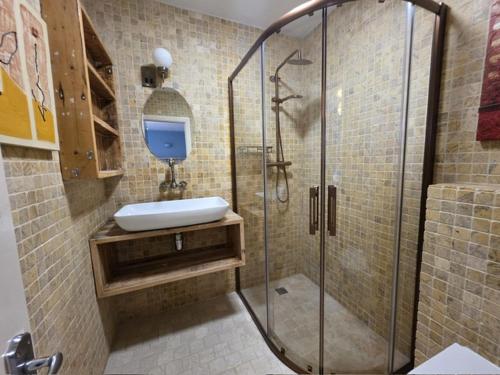 a bathroom with a shower and a sink at Connemara National Park Lodge in Letterfrack