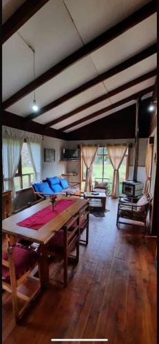 a living room with a table and a couch at Cabañas El Nuevo Cimarrón in Puerto Varas