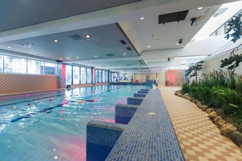 a large swimming pool in a large building at Finlandia Hotel Imatran Kylpylä Spa in Imatra