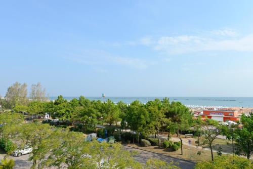 a view of a park with the ocean in the background at Hotel Flora in Cesenatico