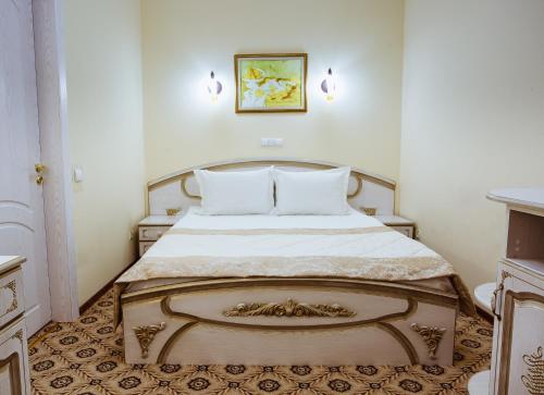 a bedroom with a large bed in a room at Hotel Natalia 18 in Lviv