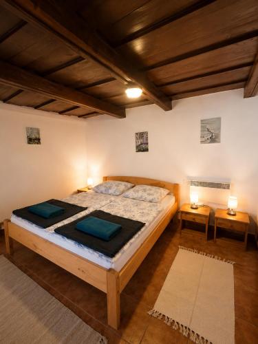 a bedroom with a large bed and two tables at 100 éves Présház in Badacsonyörs