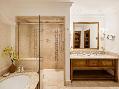 a bathroom with a tub and a sink and a shower at Palacio Nazarenas, A Belmond Hotel, Cusco in Cusco
