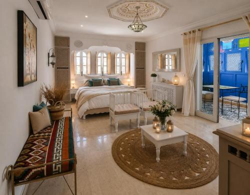 a large bedroom with a bed and a living room at DAR COLIBRI - Maison de charme à Kélibia in Kelibia