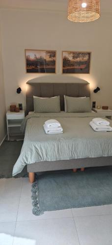 a bedroom with a bed with two towels on it at Ellotis Stone Retreat in Áyioi Dhéka