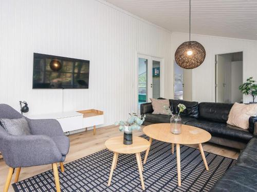 a living room with a couch and a table at 5 star holiday home in Jerup in Jerup