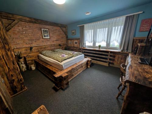 a bedroom with a bed sitting on a wooden platform at Planinski dom Janče in Ljubljana