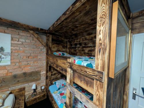a log cabin with two bunk beds in a room at Planinski dom Janče in Ljubljana
