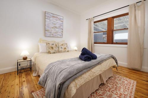 a bedroom with a large bed and a window at Delightful Digs on David in Albury