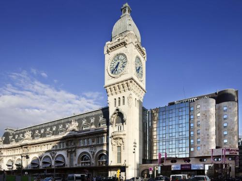 a clock tower on top of a building at Mercure Paris Gare De Lyon TGV in Paris